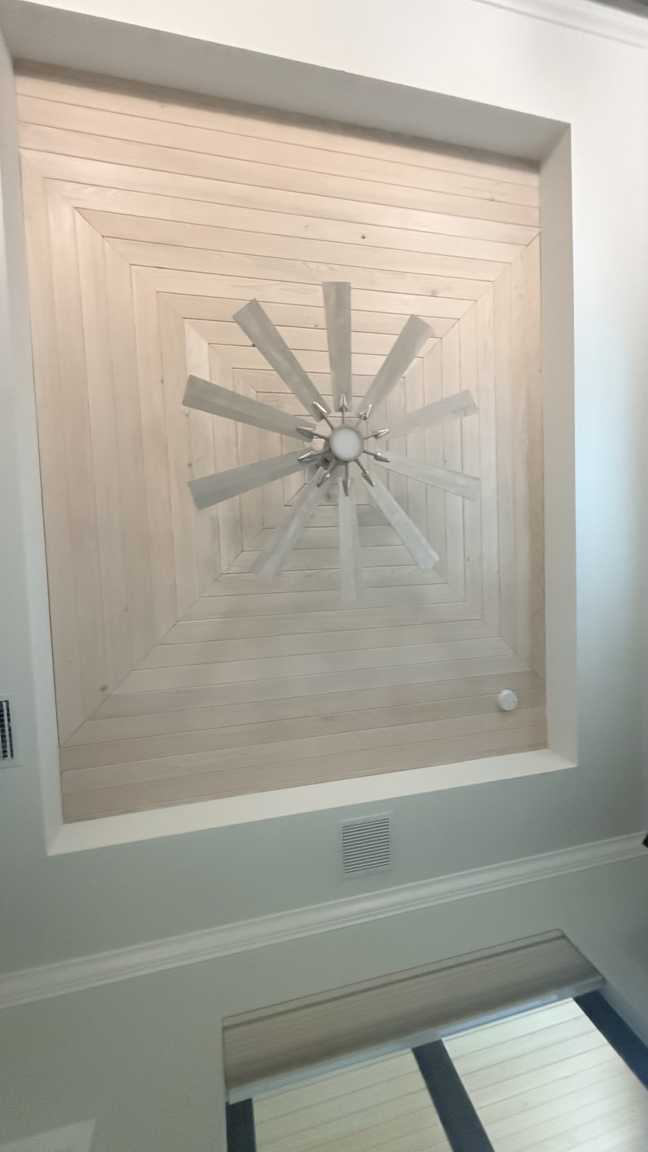 Built-in entertainment center with green accent wall and LED shelving