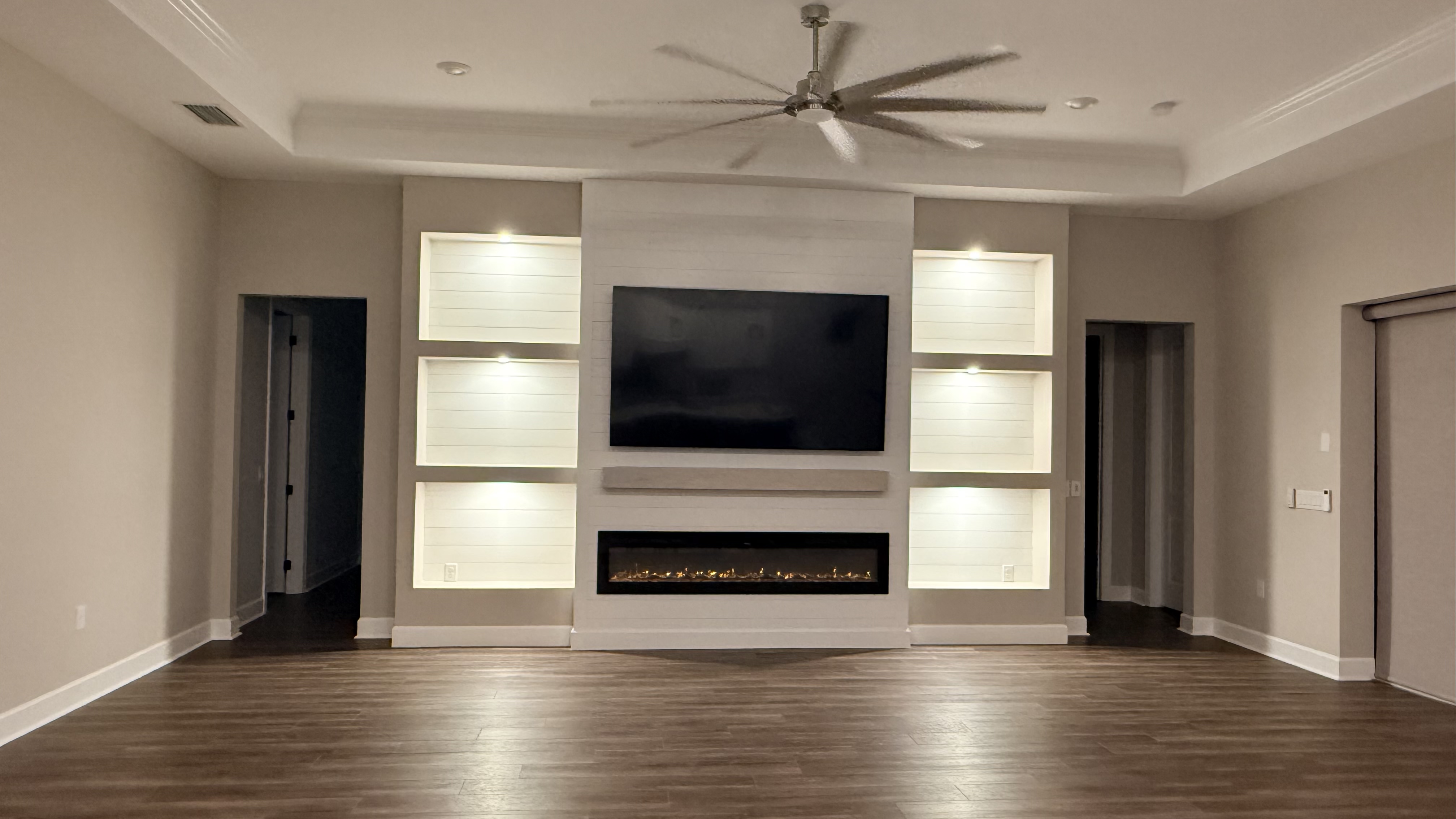 Large format entertainment wall with TV niche and surrounding shelving