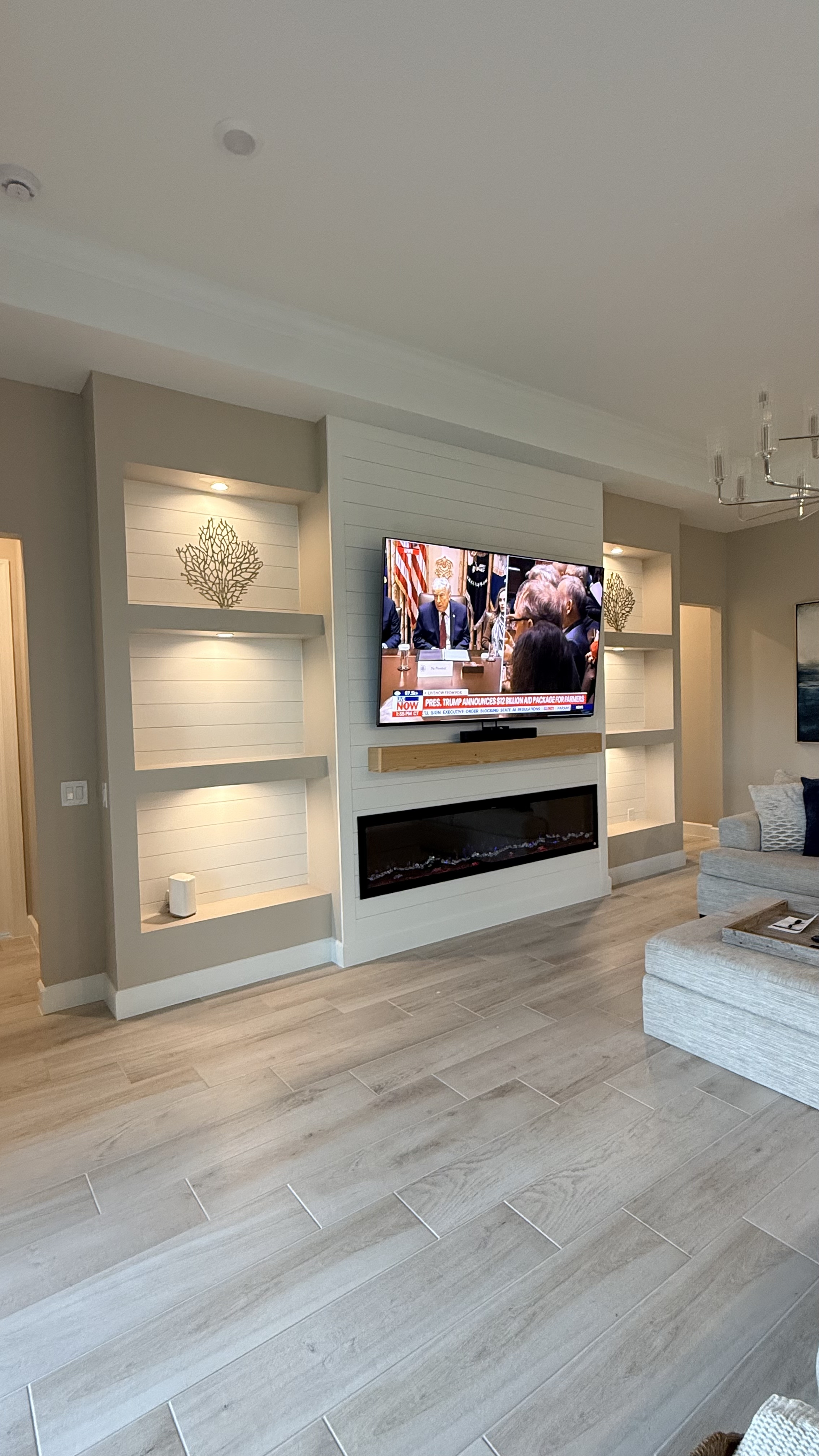 Modern TV wall with built-in shelving and LED accent lighting