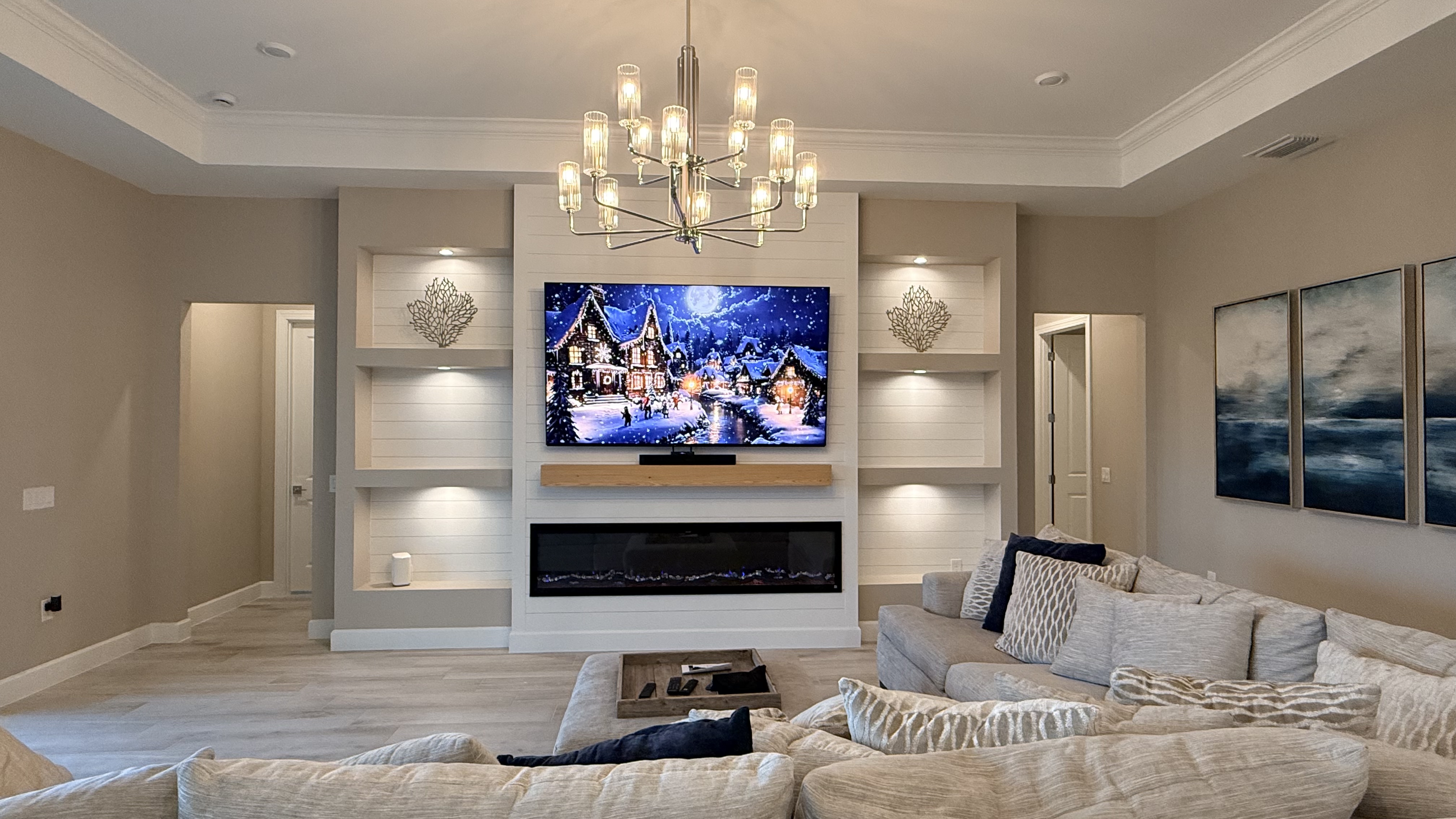 Built-in TV wall with surrounding cabinetry and open shelving